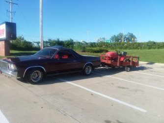 78 el Camino hauling trailer with red mowers.jpeg
